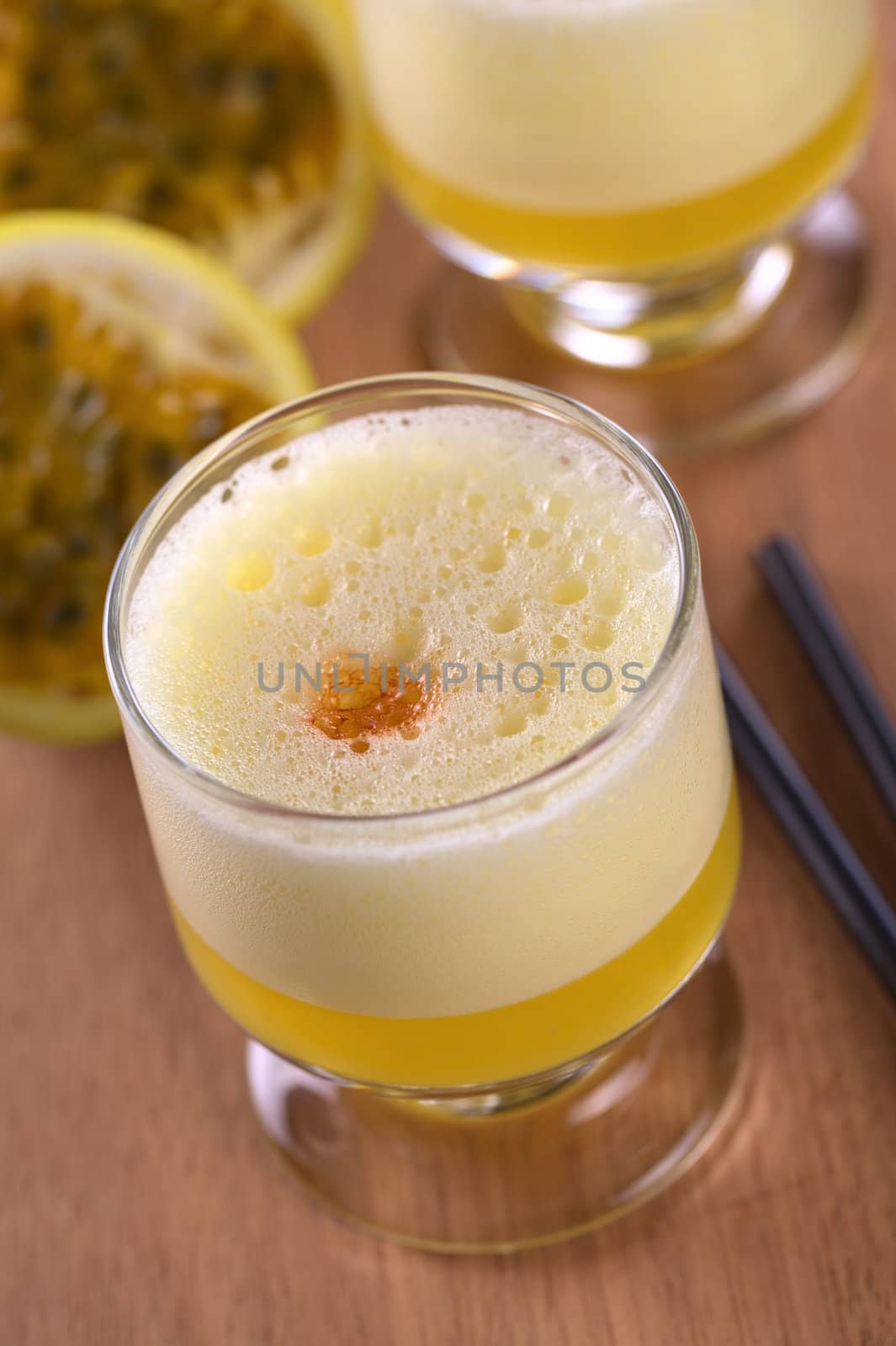 Maracuya Sour, a popular Peruvian cocktail made of maracuya and lime juice, pisco, syrup and egg white (Selective Focus, Focus on the middle of the froth around the angostura drop)