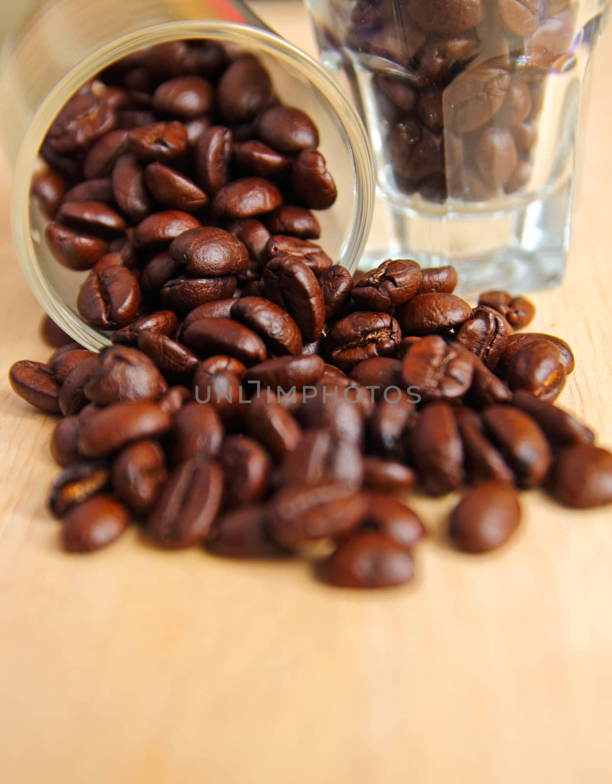Coffee beans in glasses on wooden background by nuchylee