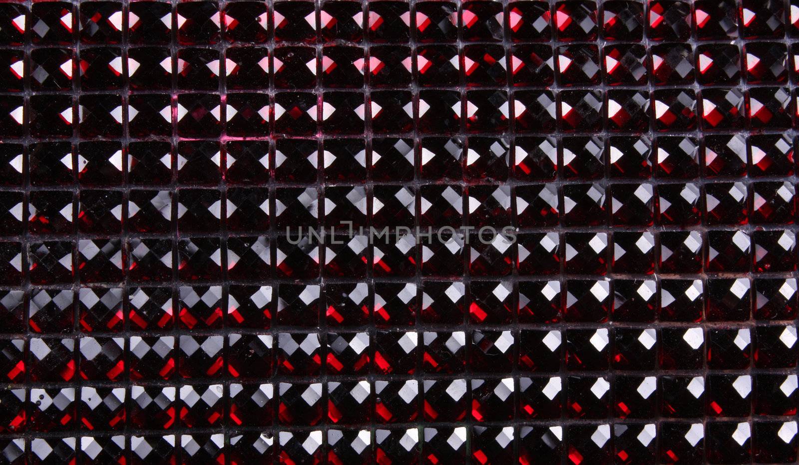 A background with a horizontal pattern of crimson and red gemstones.