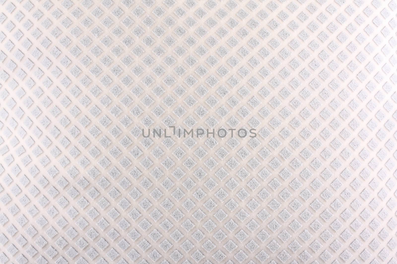 A background of a white fabric with an abstract design of diamond shapes on it.