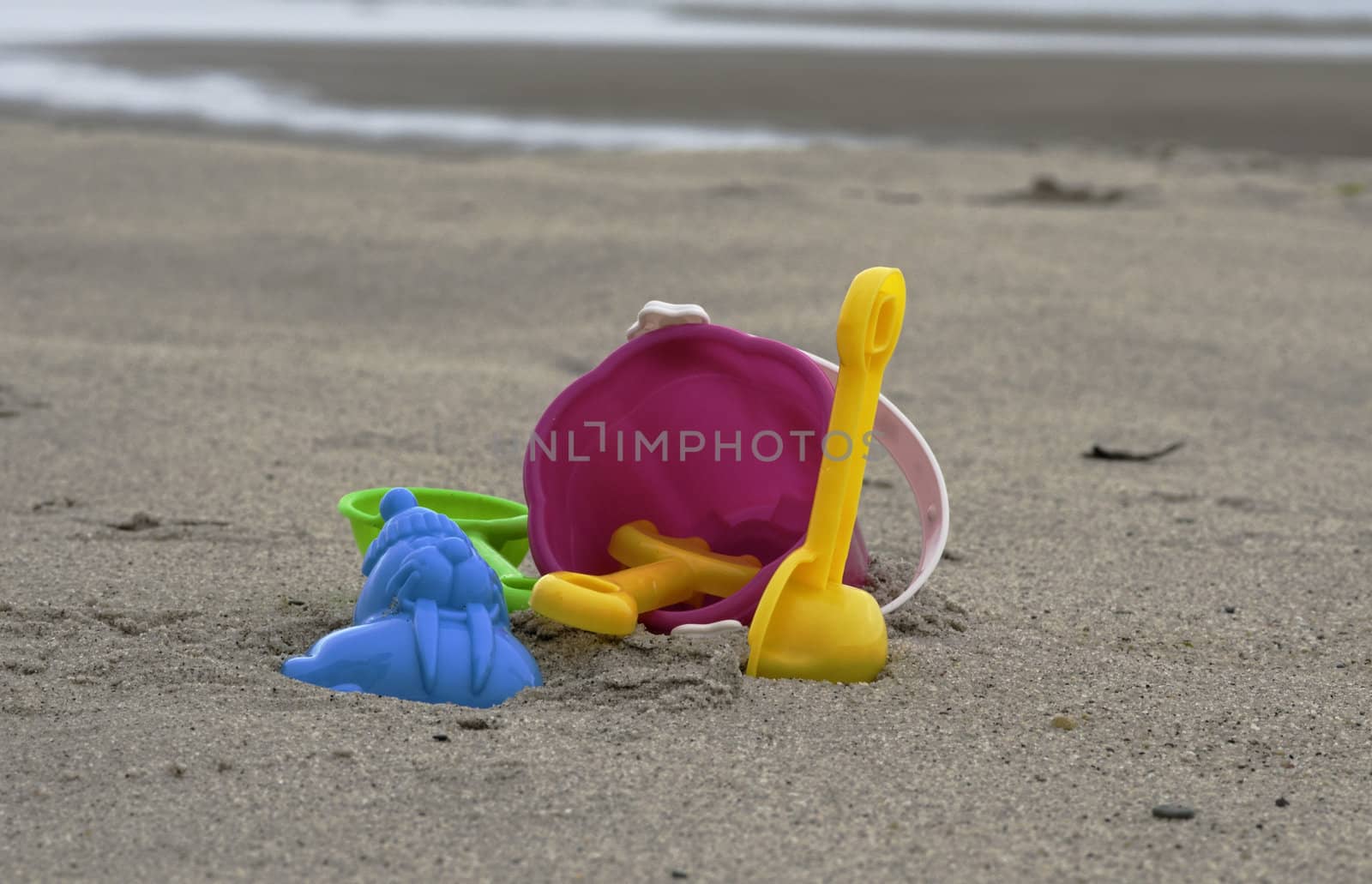 plastic toys on the beach with bucket sppon and rake