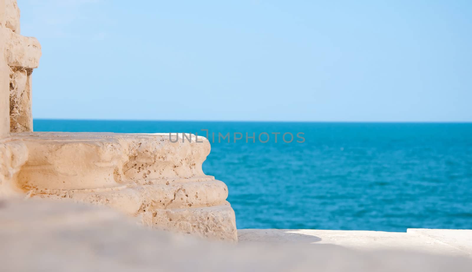 detail of old italian architecture in trani and blue sea background