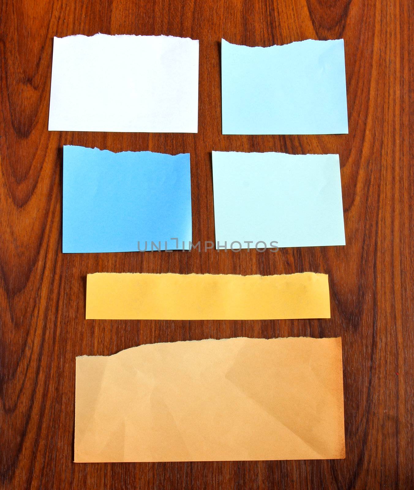 Ripped notepaper on wooden background