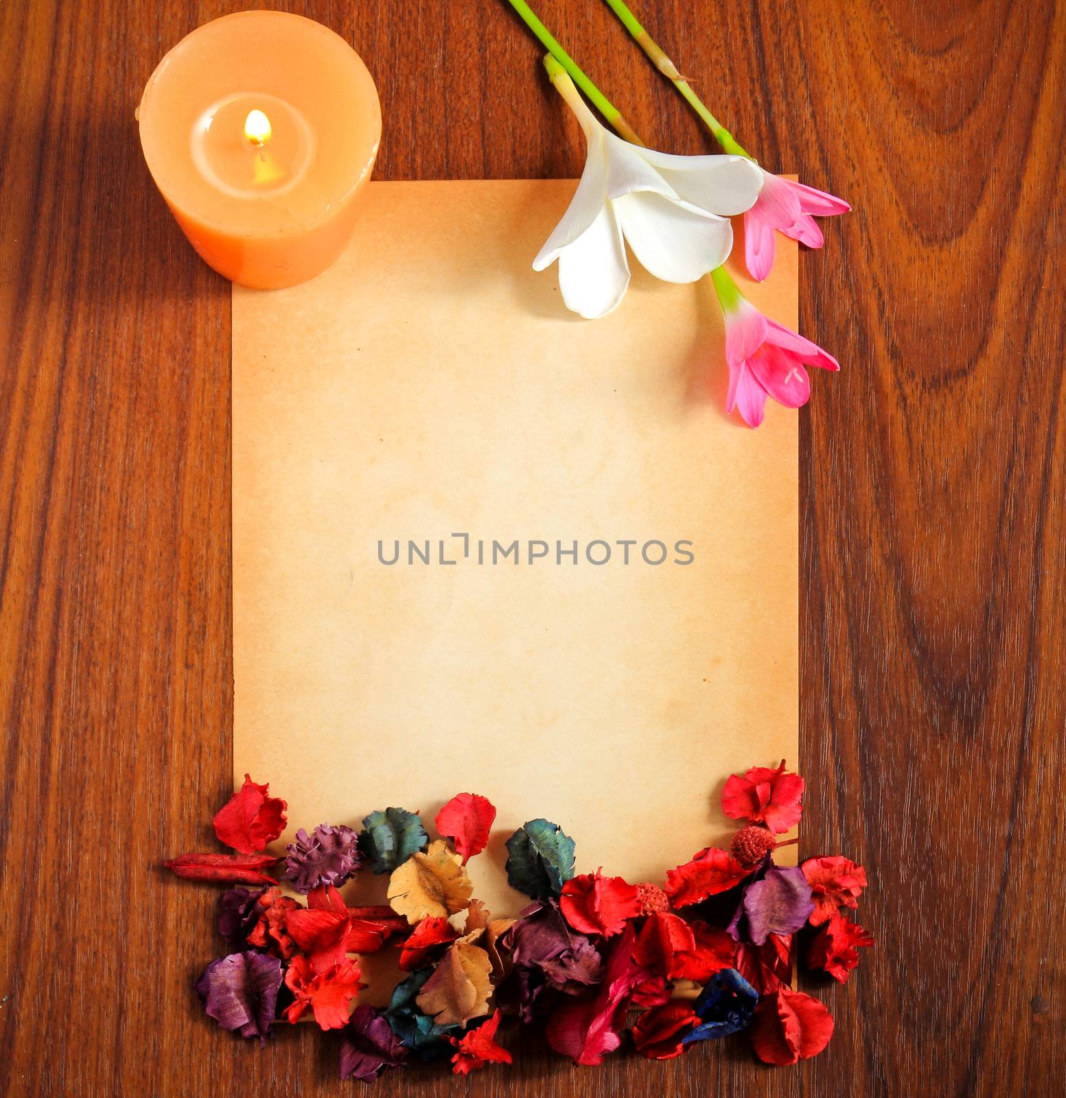 old paper with dry flower and candle on wooden background by nuchylee