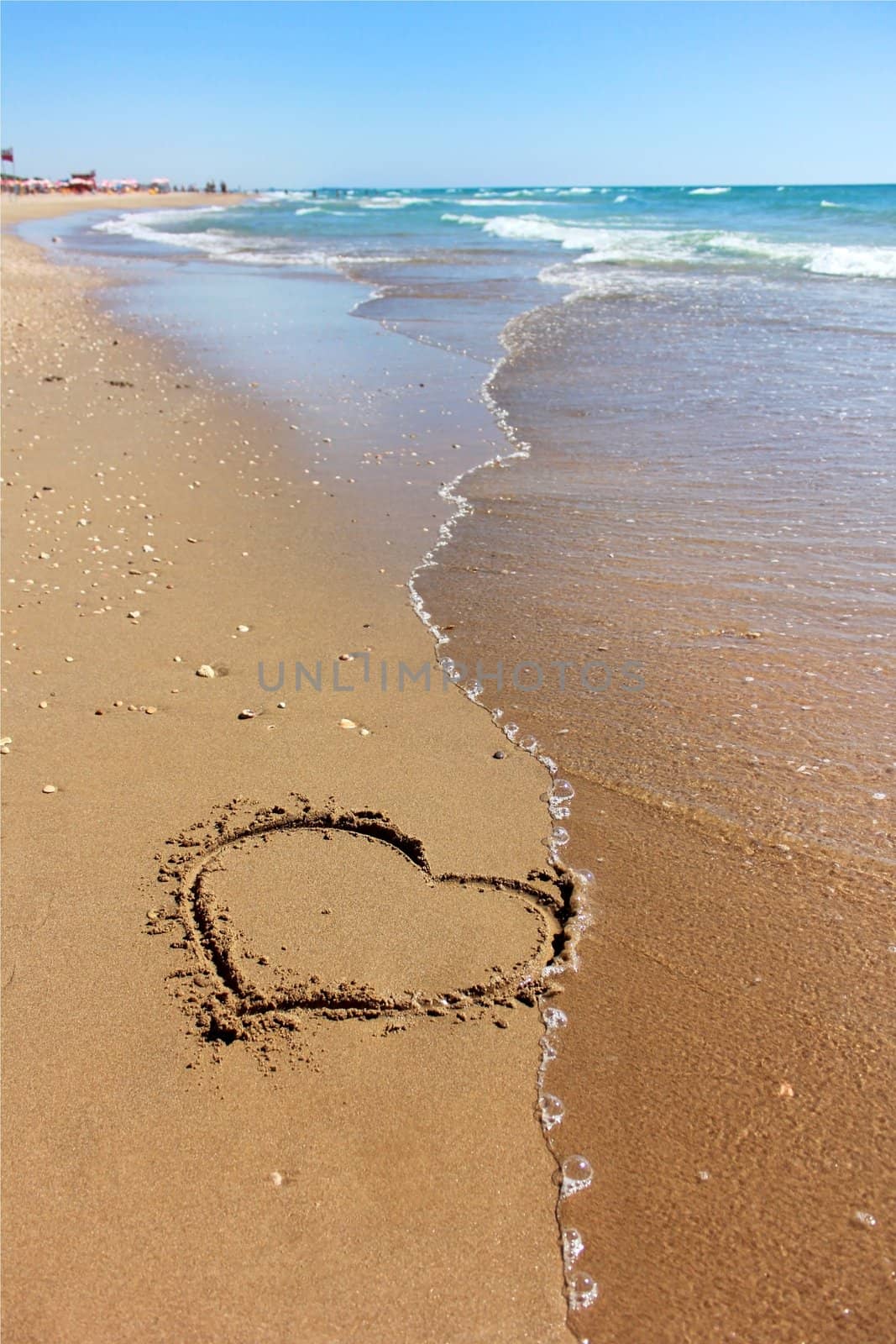 drawing a heart on sandy beaches of the Mediterranean
