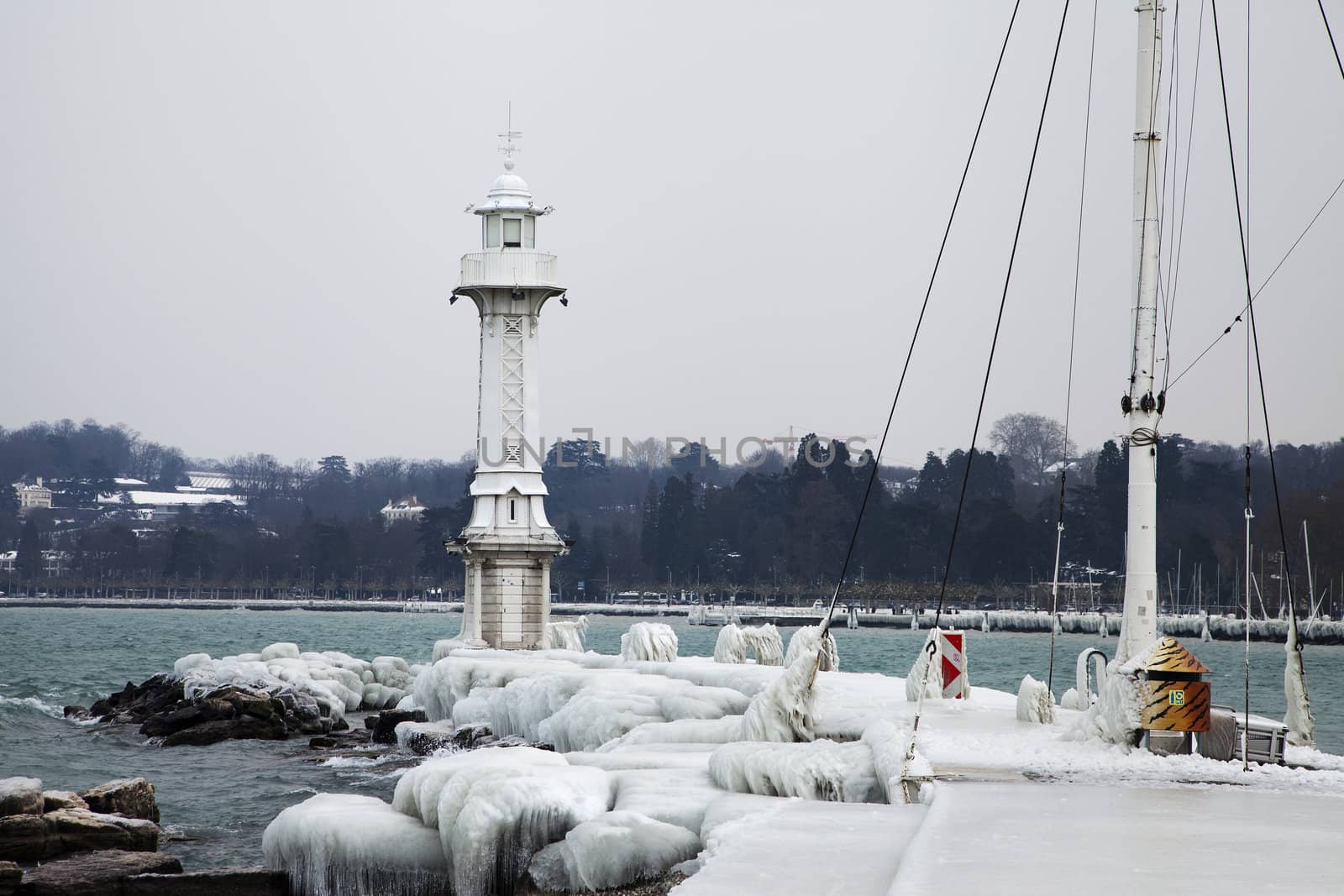 Lighthouse in Geneva, Switzerland is covered by ice during winter