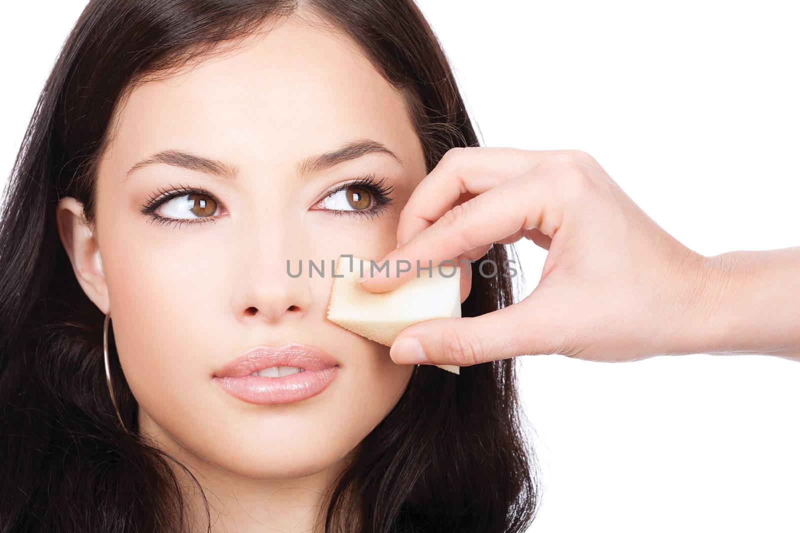 pretty woman applying make up with cosmetic sponge, isolated on white background