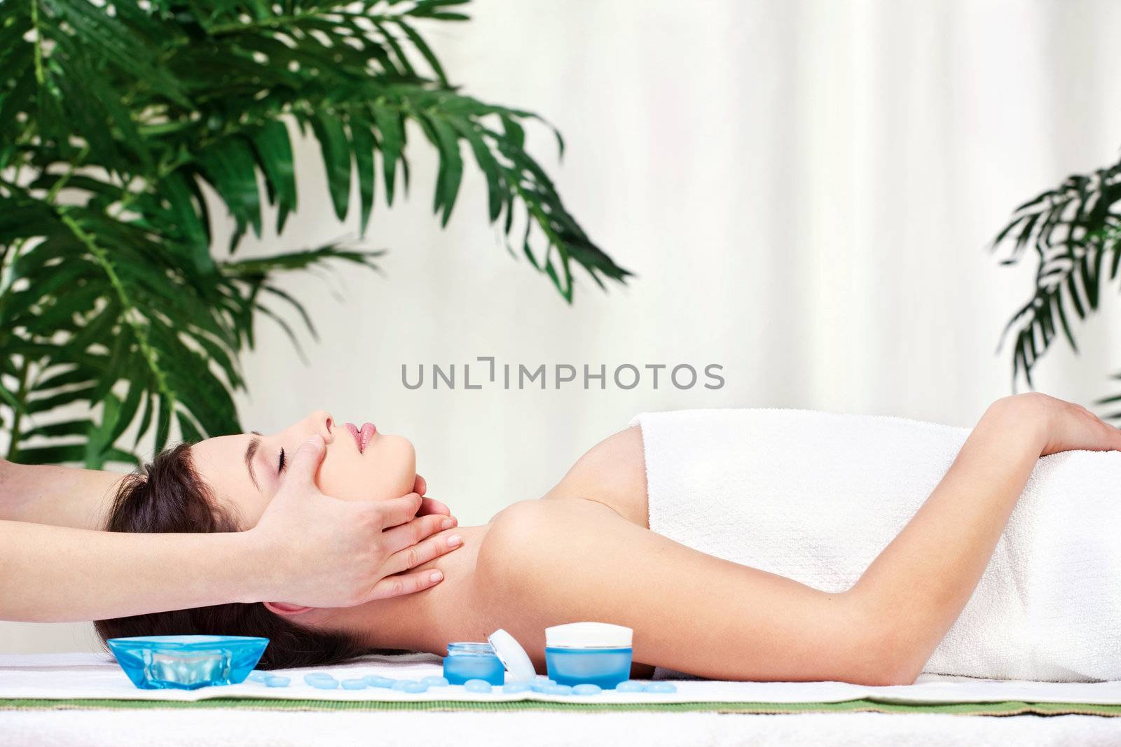 Pretty woman on head massage in spa center
