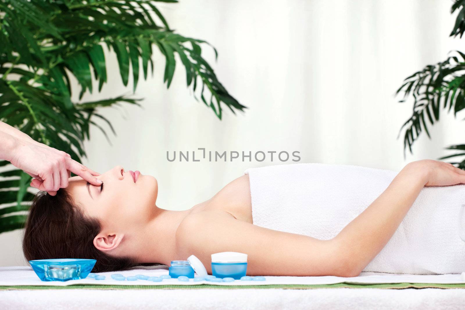 Pretty woman on head massage in spa center