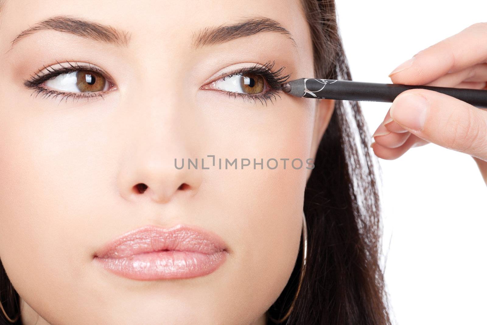 close up look of applying cosmetic pencil on woman's eye, isolated on white background
