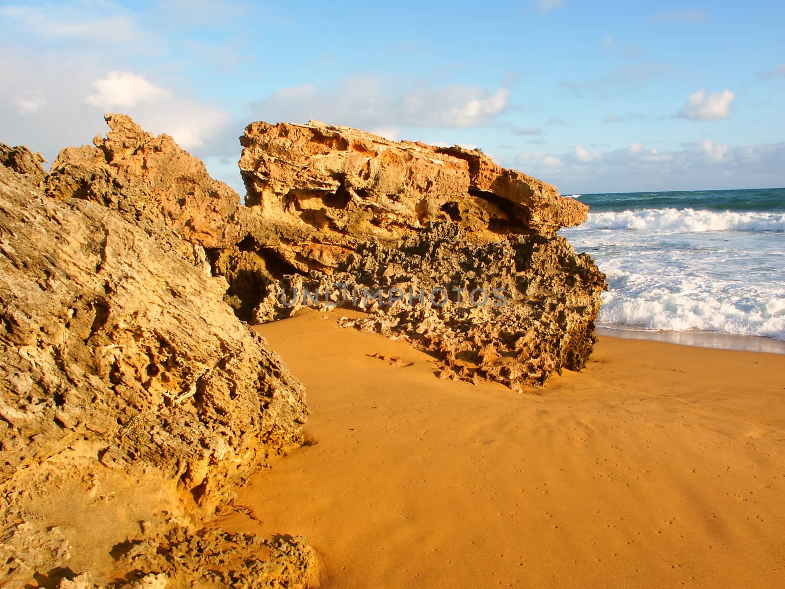 Rugged rocks jut out of the beach along the southern coast of Victoria, Australia.