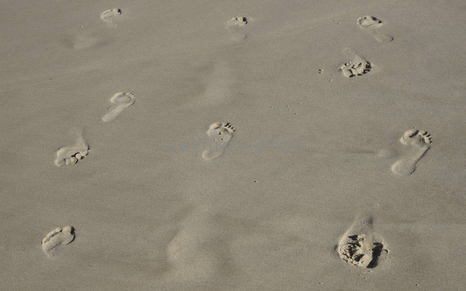 indecision with footprints in sand going back and forth