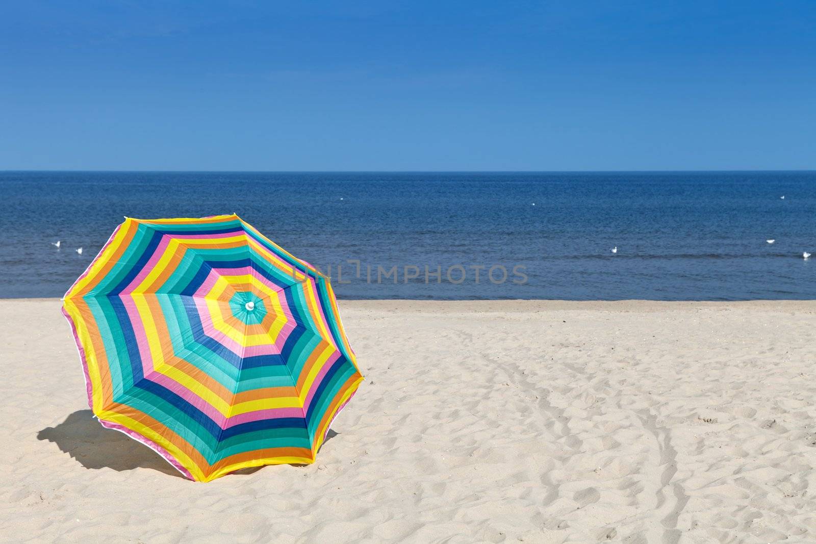 Umbrella on a sandy beach, summer time