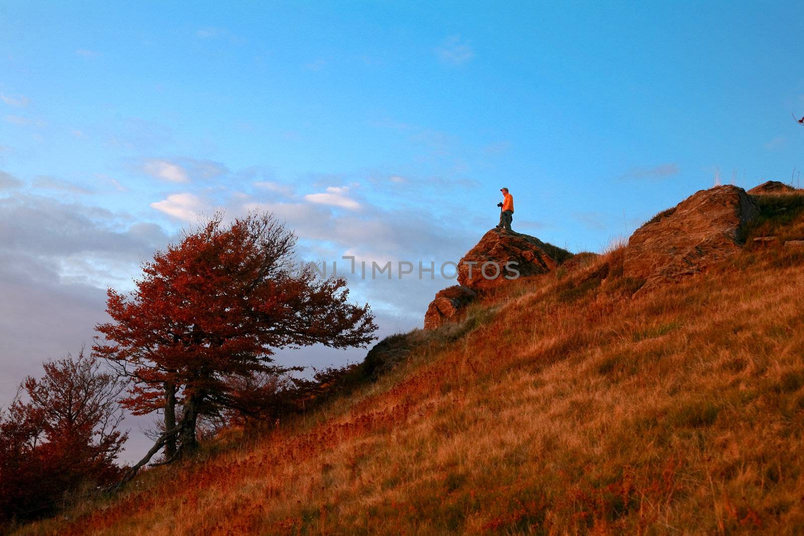 An image of a man walking in mountains