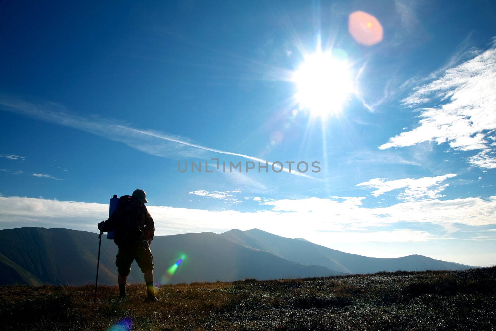 An image of silhouette of a tourist on a hill