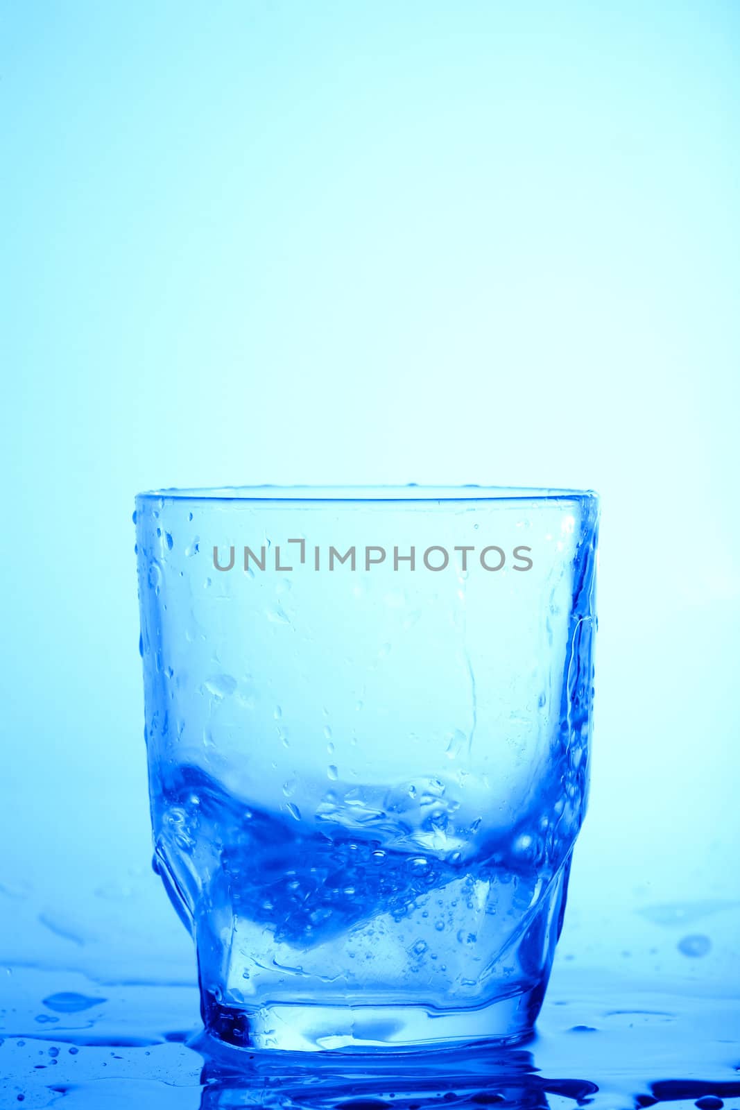 An image of a glass on blue background