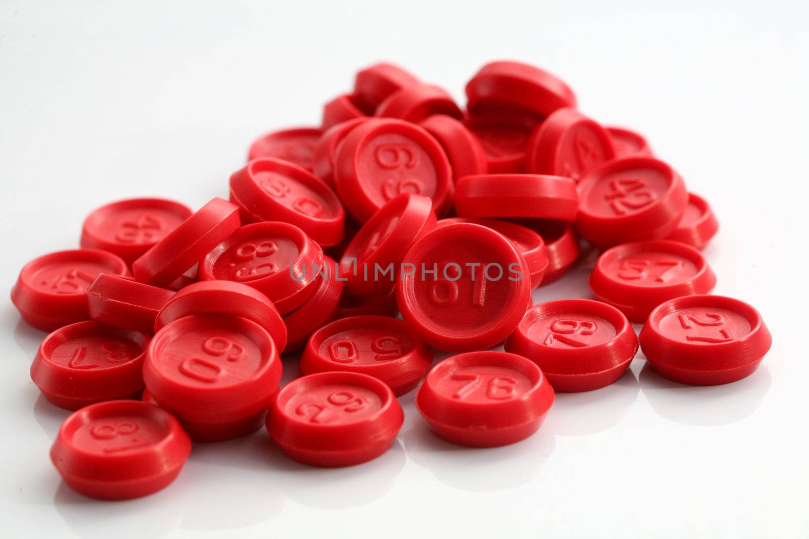 An image of red bingo game chips on white background
