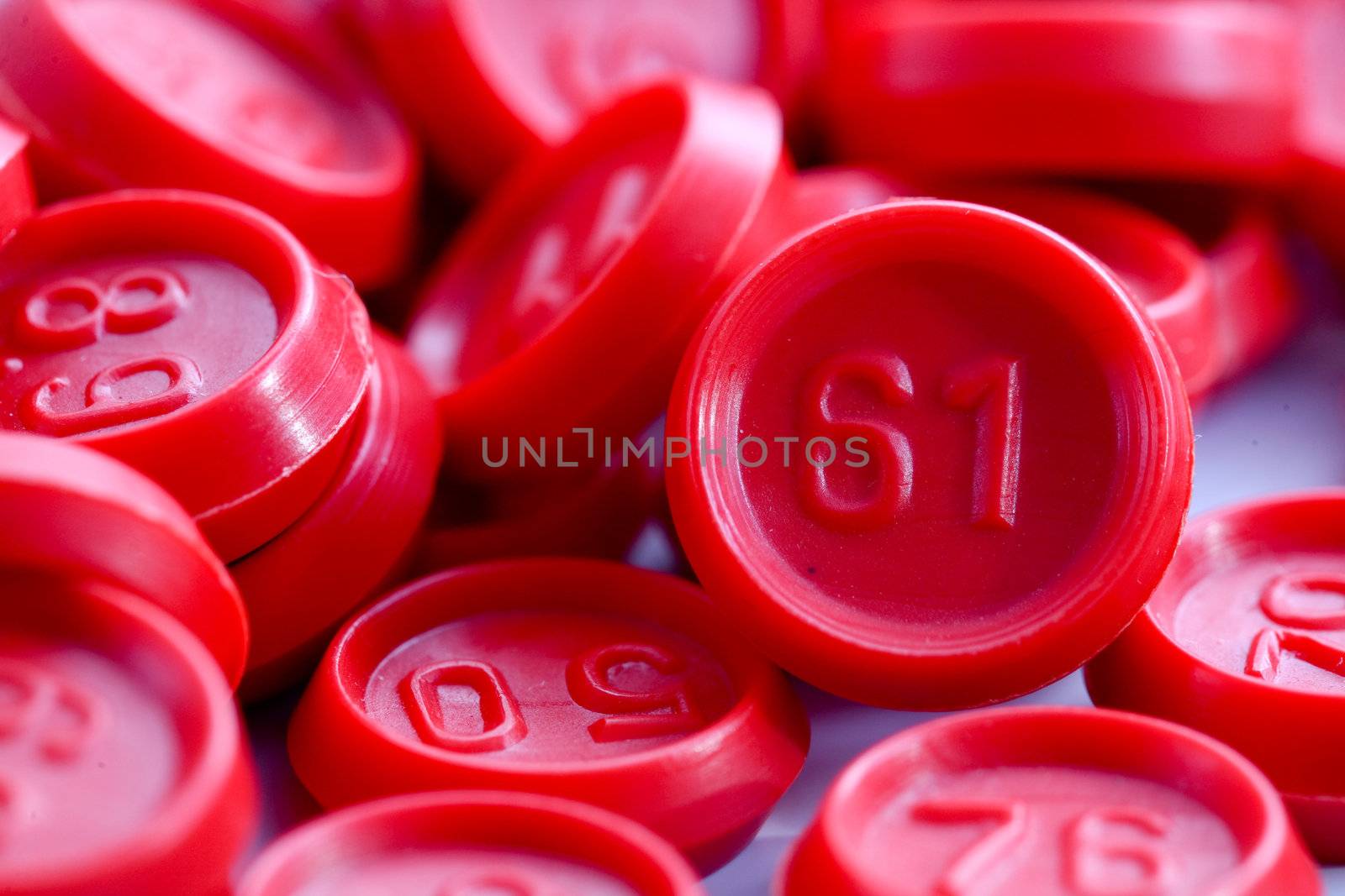 An image of red bingo game chips closeup