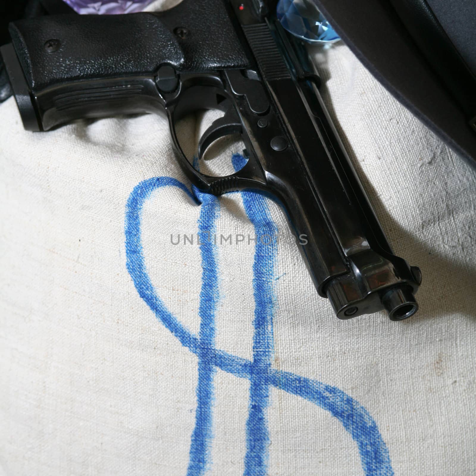 An image of a gun and a bag on a chair