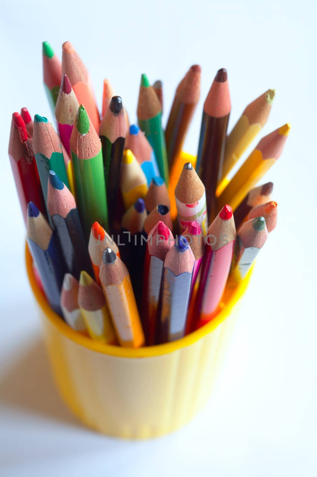 An image of various colored pencils in a plastic glass