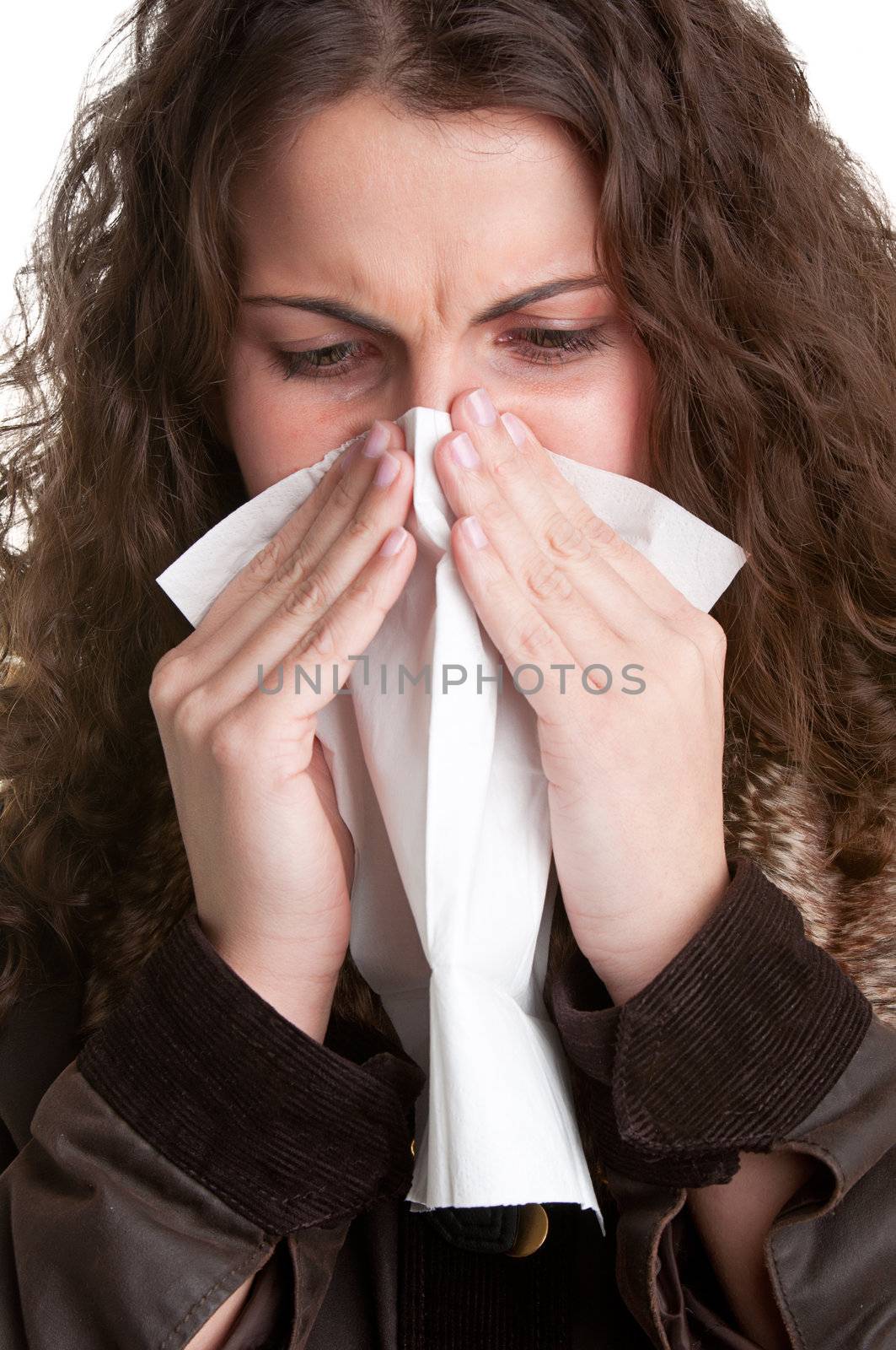 Pale sick woman with a flu, sneezing, in a white background