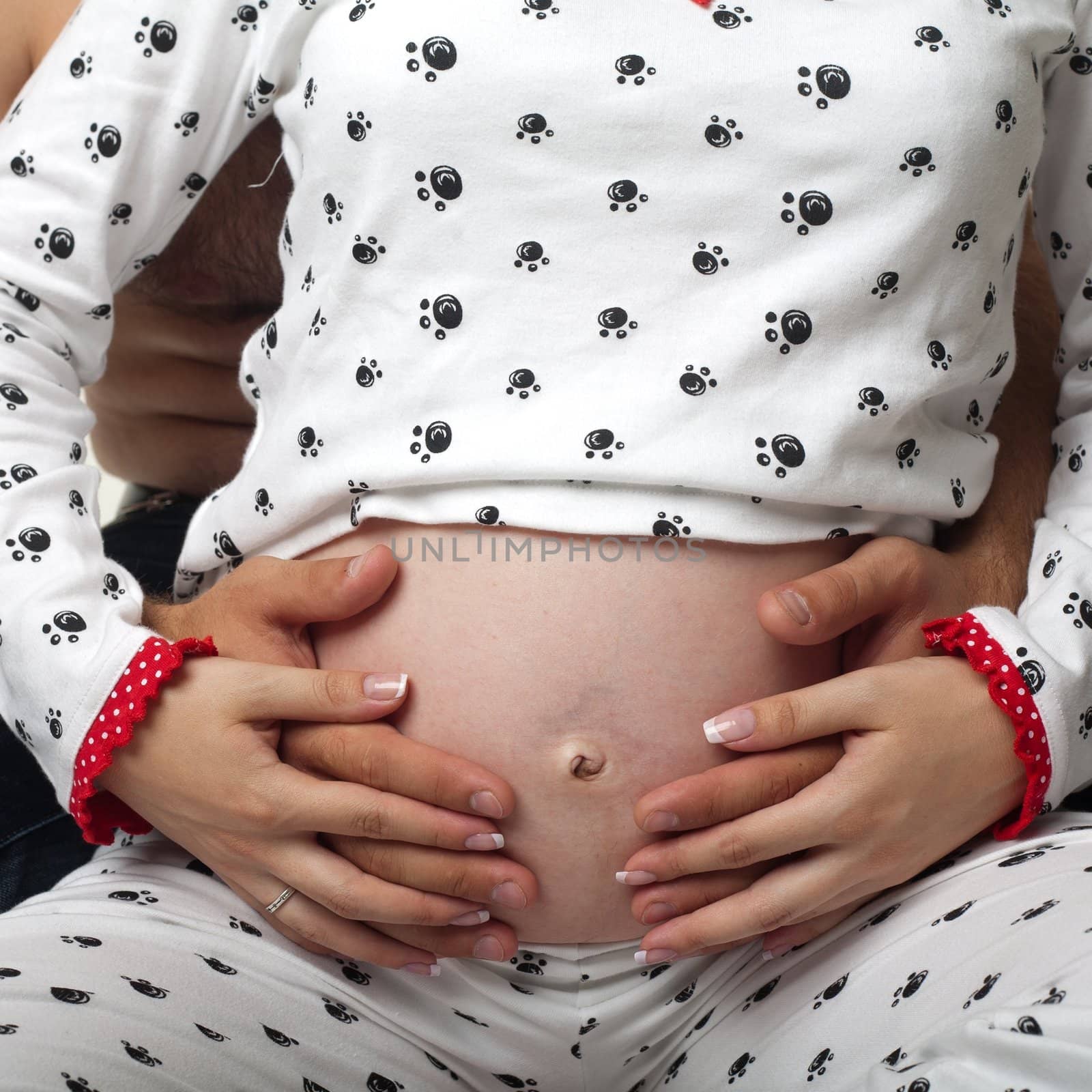 An image of pregnant woman abdomen with hands on it