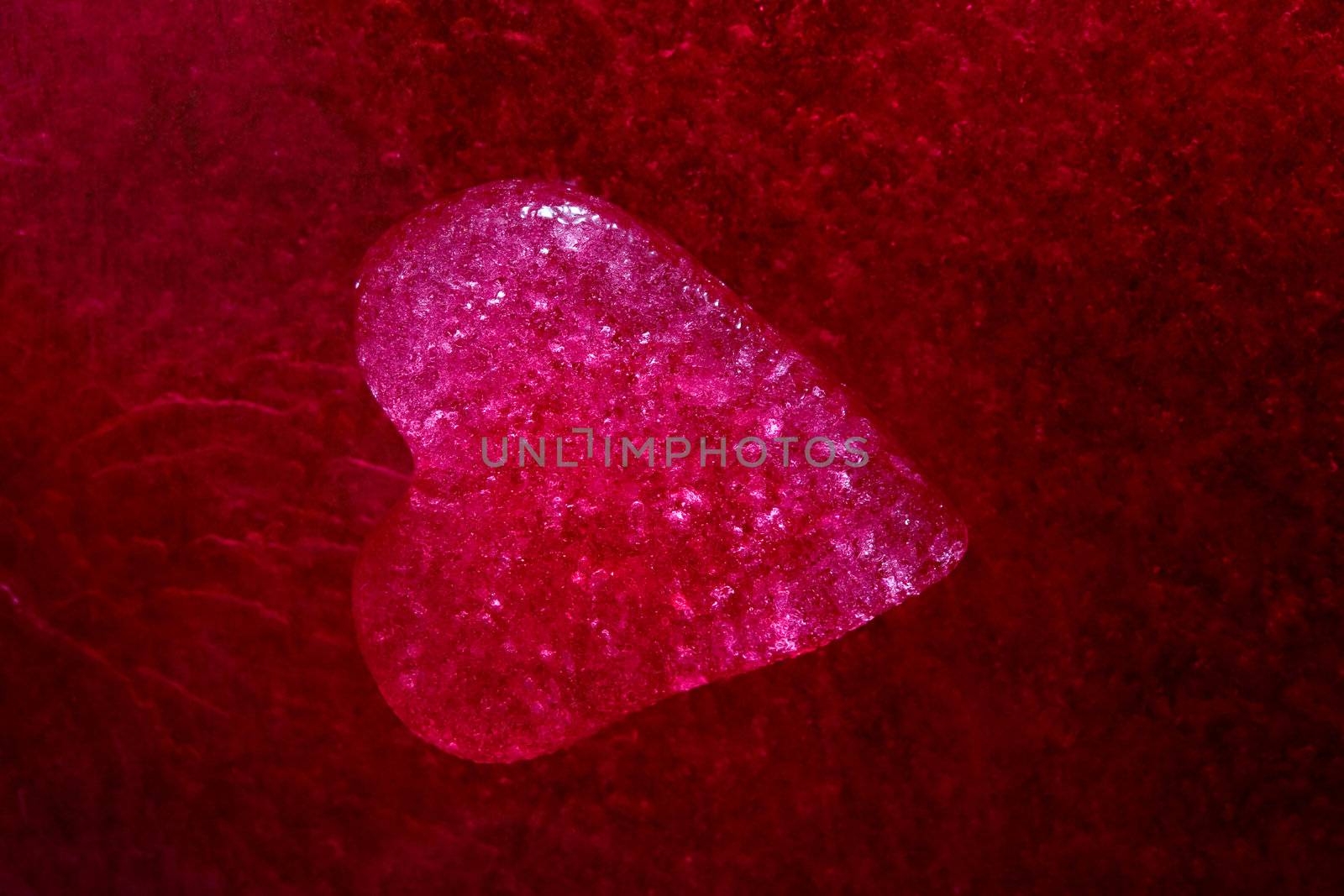 Stock photo: an image of a red icy heart on a purple background
