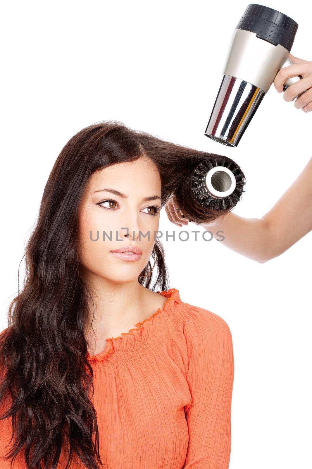 hairdresser combing and dry the hair of a woman, isolated on white background