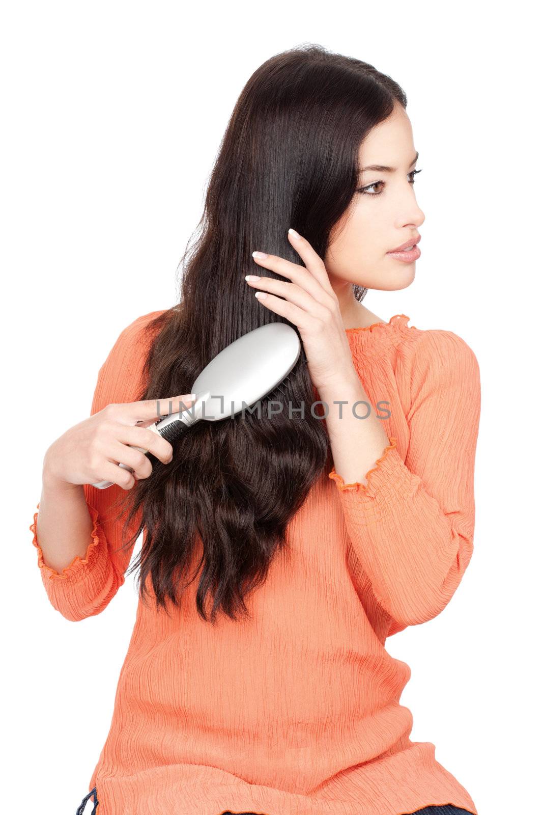 pretty woman combing her long black hair, isolated on white background