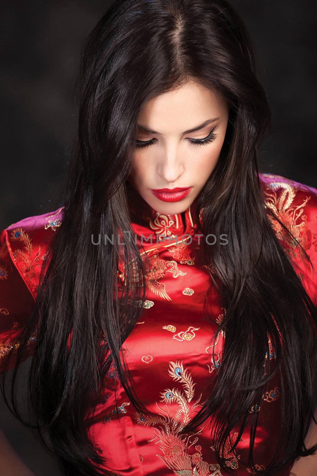 woman in red Cheongsam on dark background by imarin