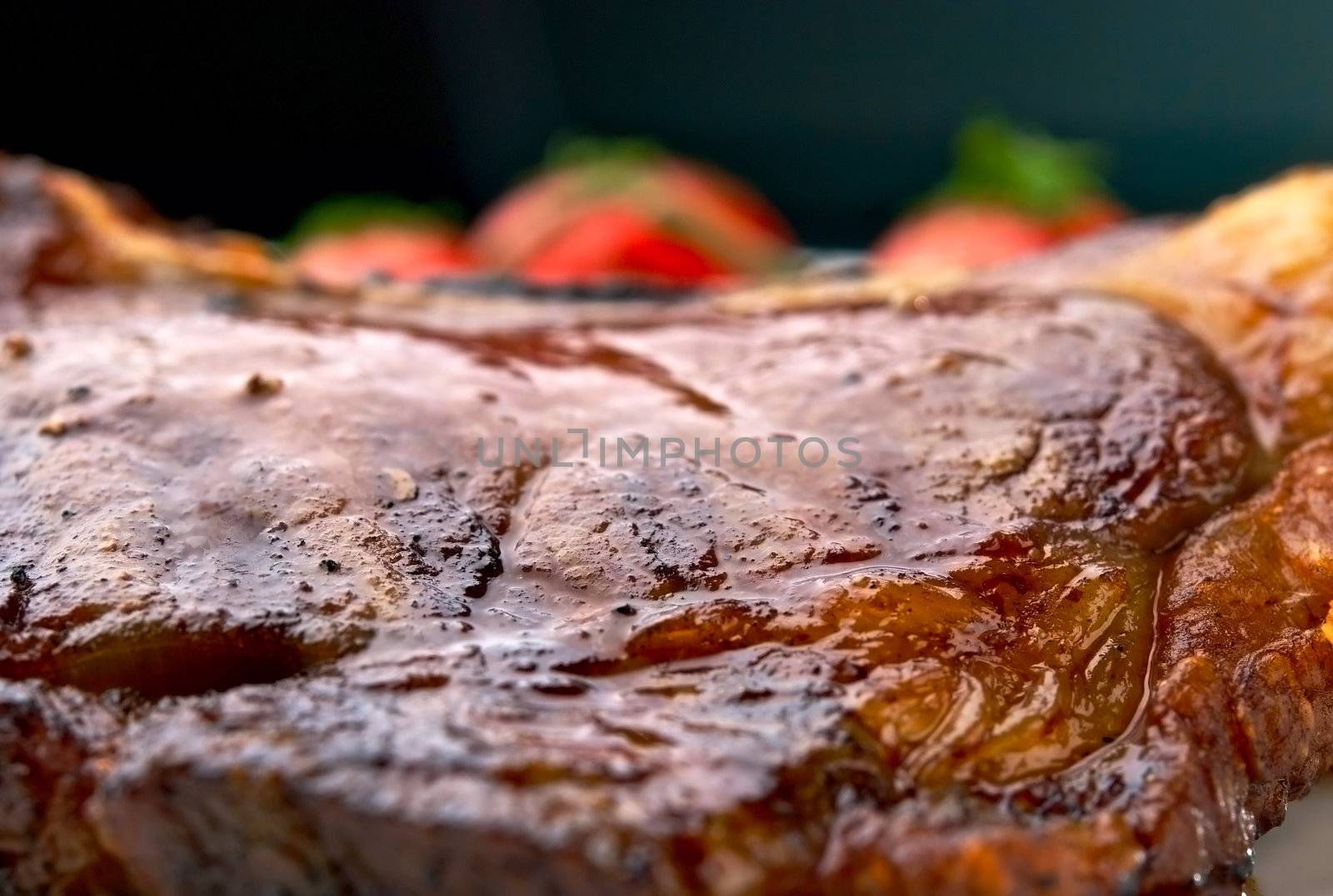 Macro of grilled meat ribs on white plate with tomatoes by kirs-ua