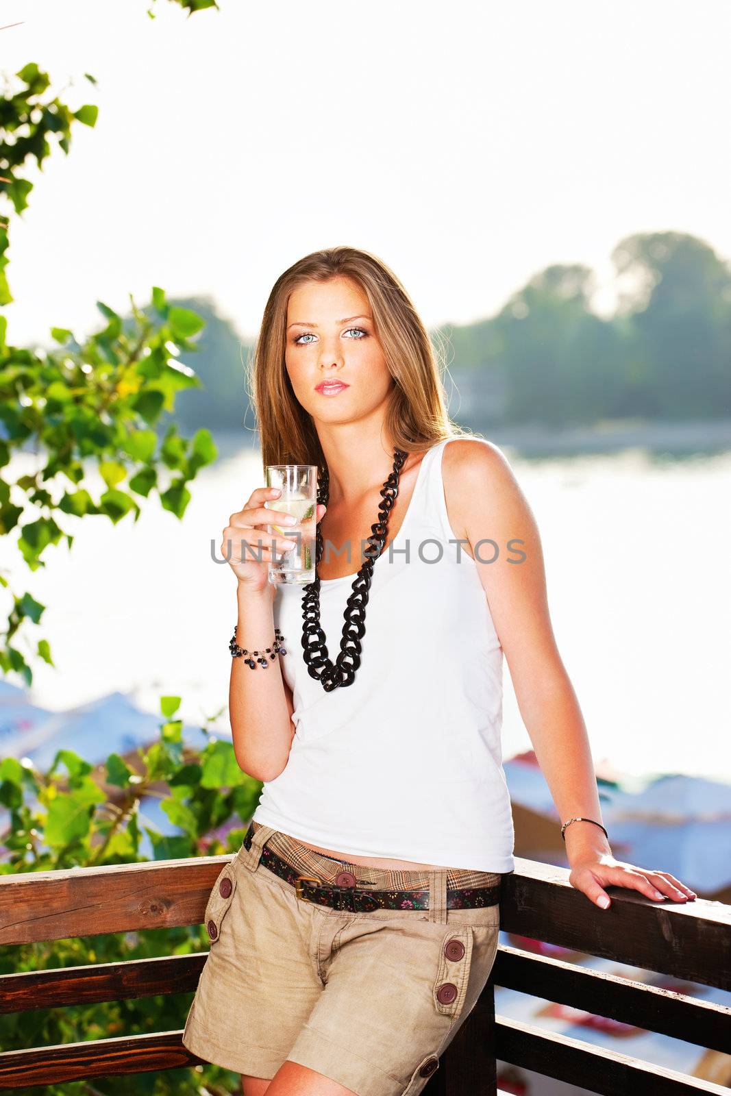 Pretty woman holding glass of water