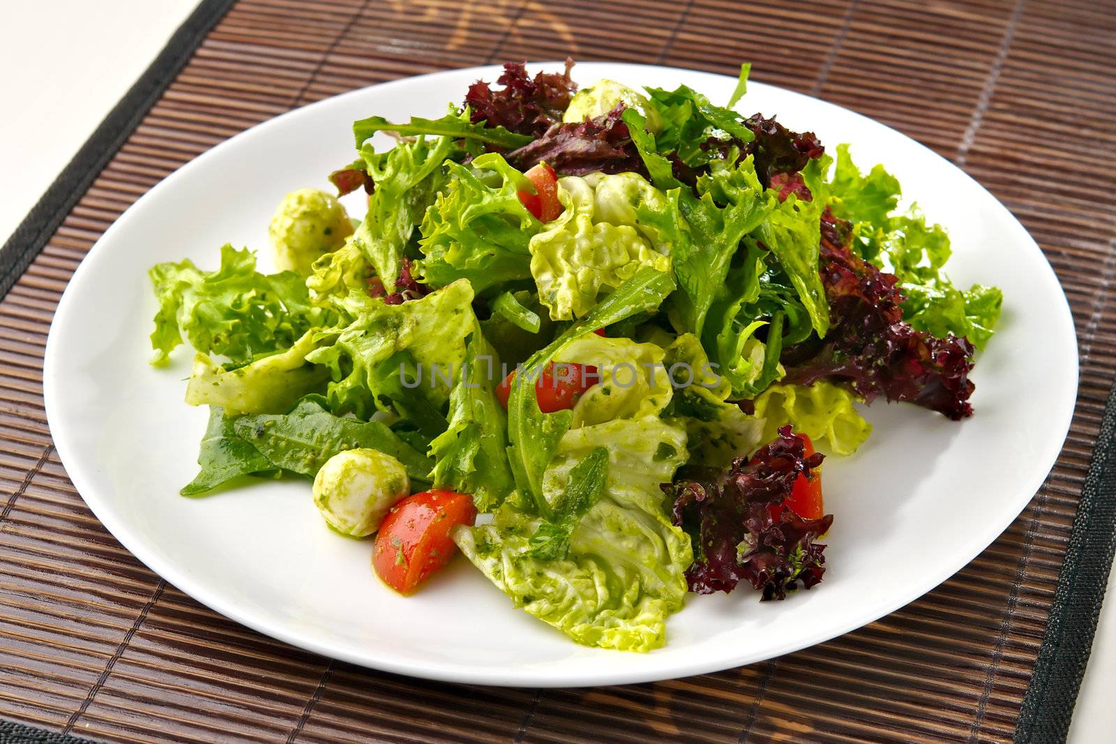 Fresh salad with mozzarella cheese and cherry tomatoes. Indoor. 