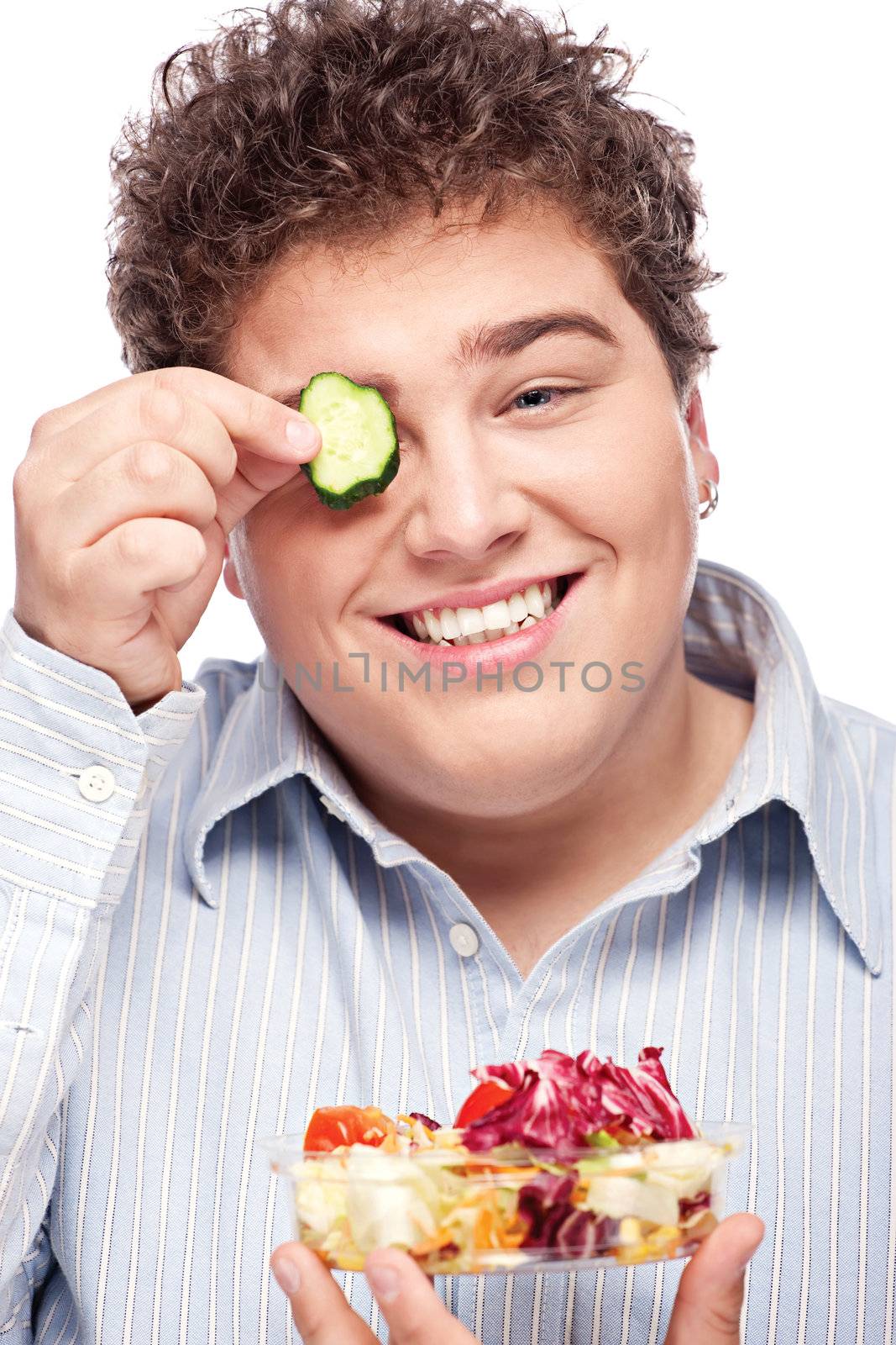 Happy young chubby man with fresh salad, isolated on white