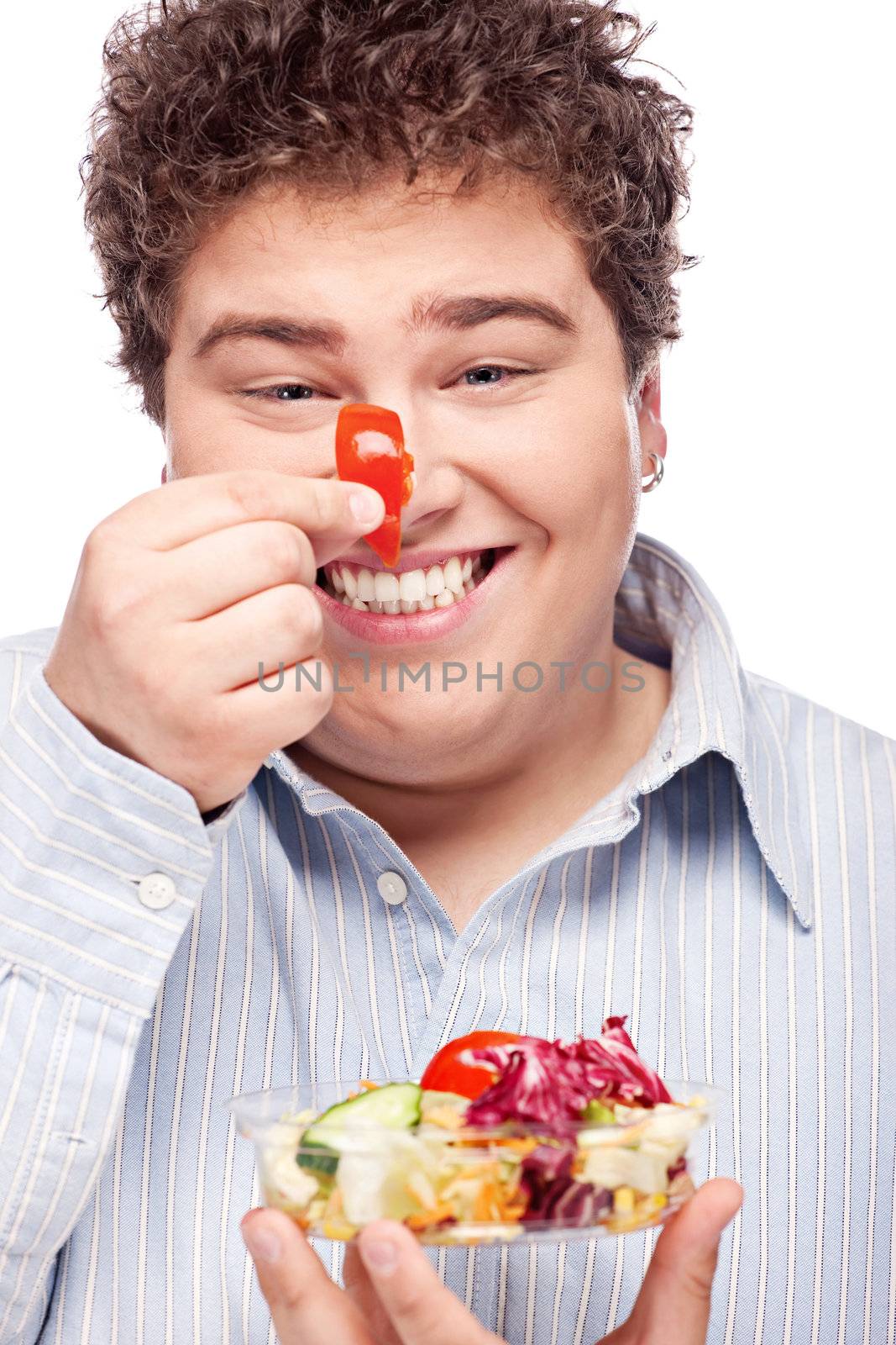 Happy young chubby man with fresh salad, isolated on white