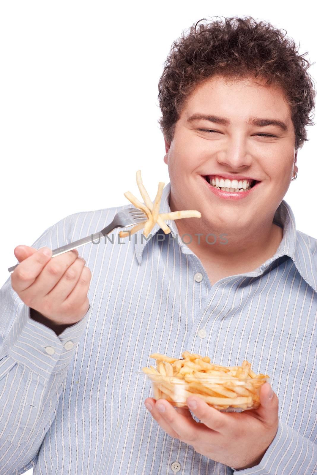 Happy young chubby man with pommes frites in dish, isolate on white