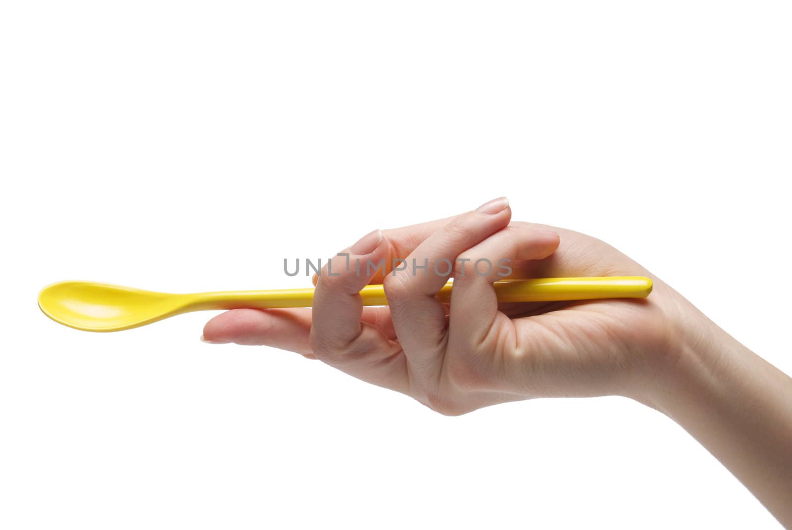 Hand holding an empty teaspoon, isolated on white background