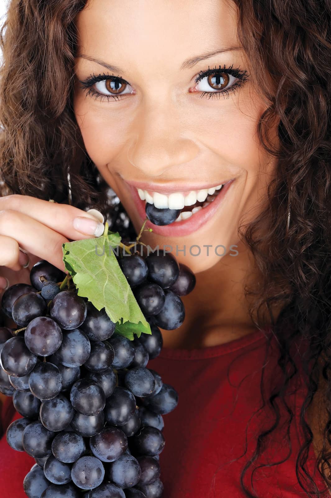 Close up of a pretty woman eating grape