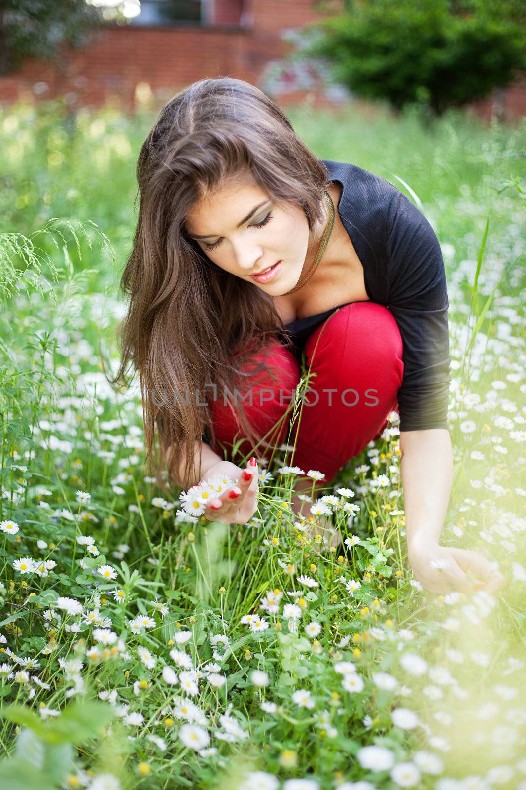 woman in park gather spring flowers by imarin