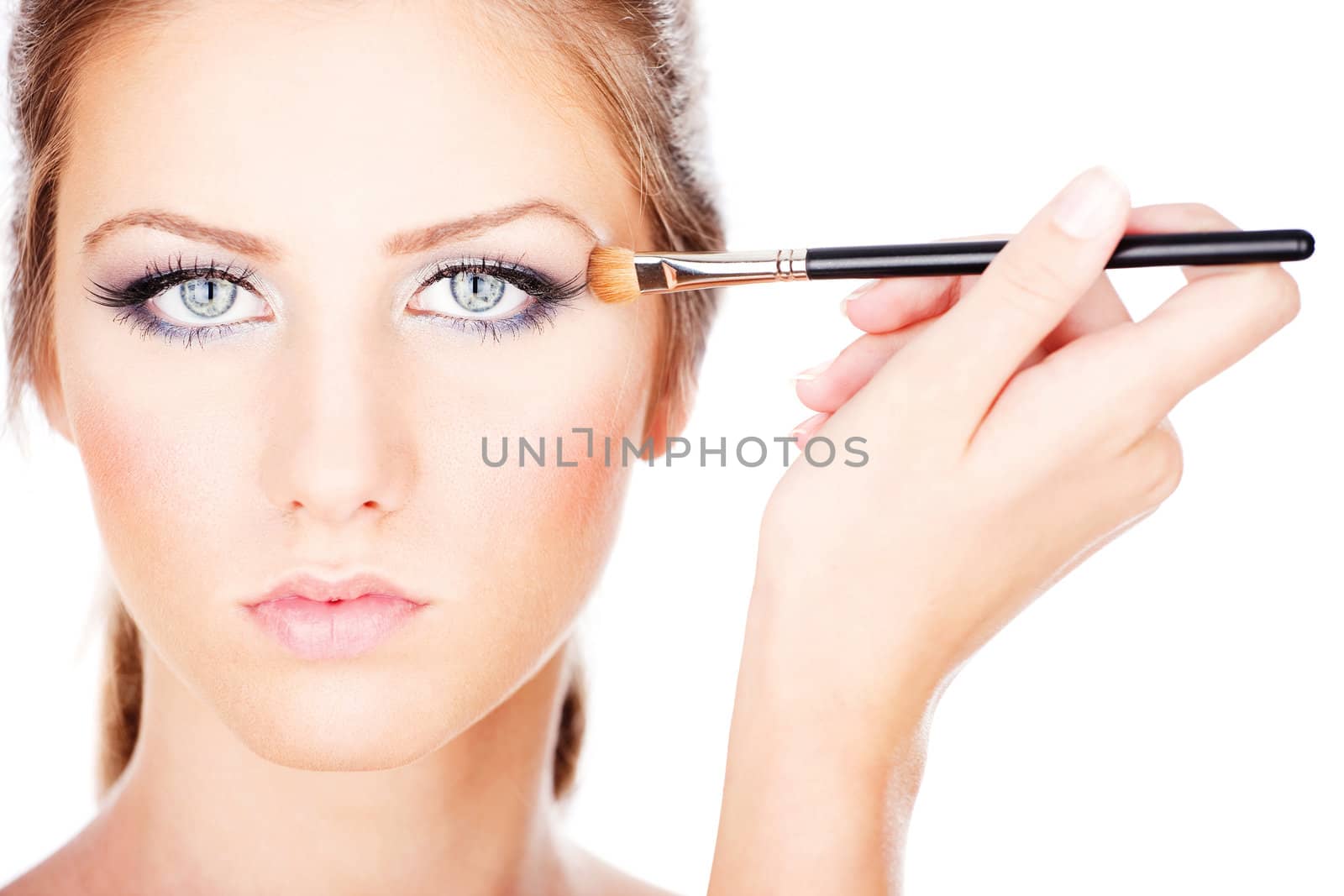 pretty woman applying make up with brush, isolate on white