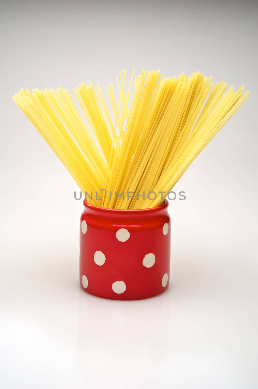 Spaghetti inside a red jar isolated on white background