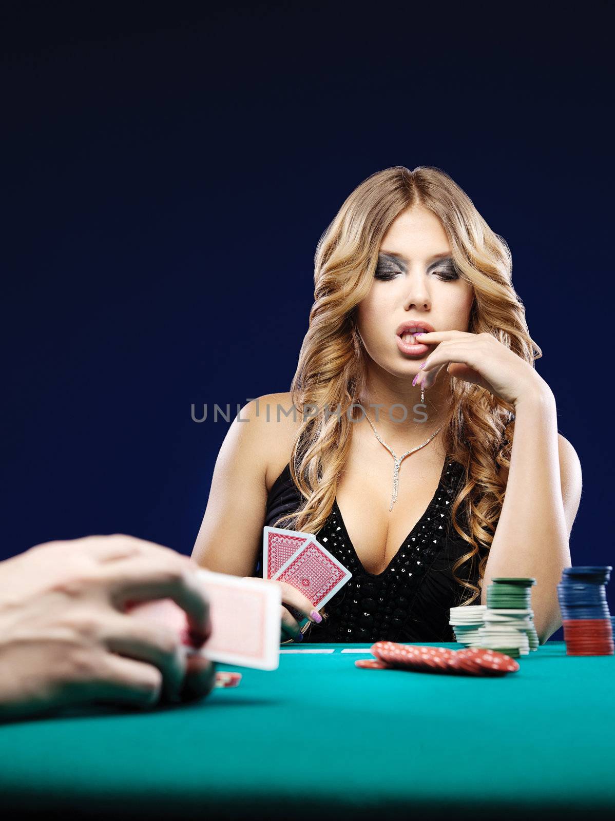 Woman doubt in a card gambling match on green table