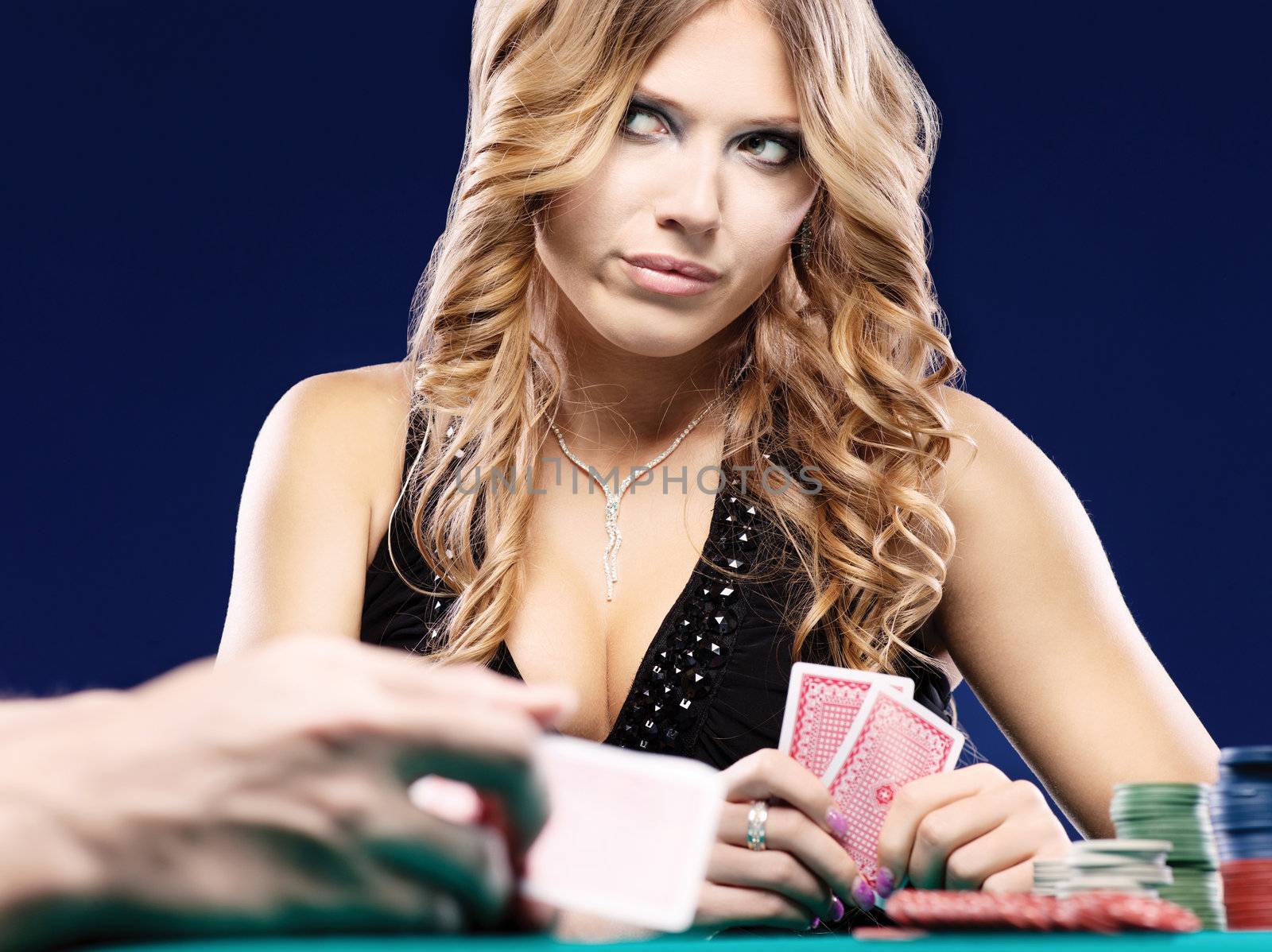 Blond woman doubt in a card gambling match