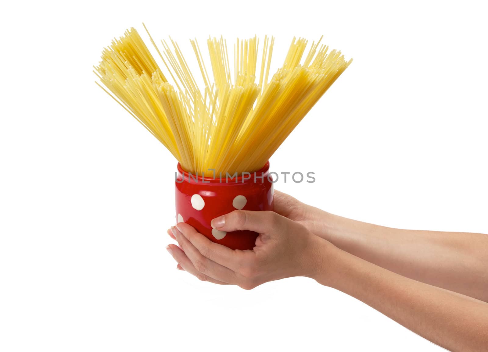 Woman's hands holding red jar full of spaghetti inside.  Isolated on a white background.