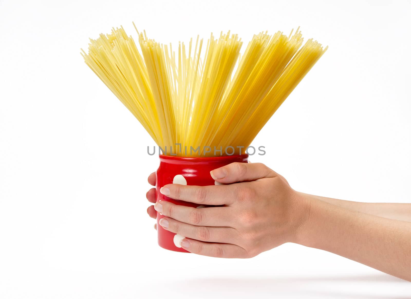 Woman's hands holding red jar full of spaghetti inside.  Isolated on a white background.