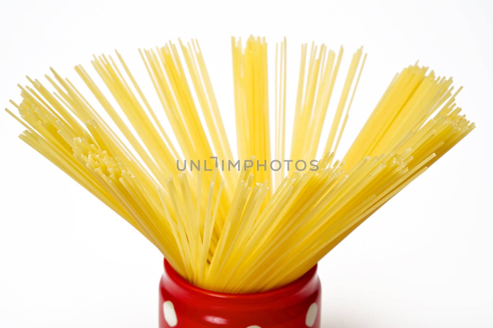 Closeup spaghetti inside a red jar isolated on white background