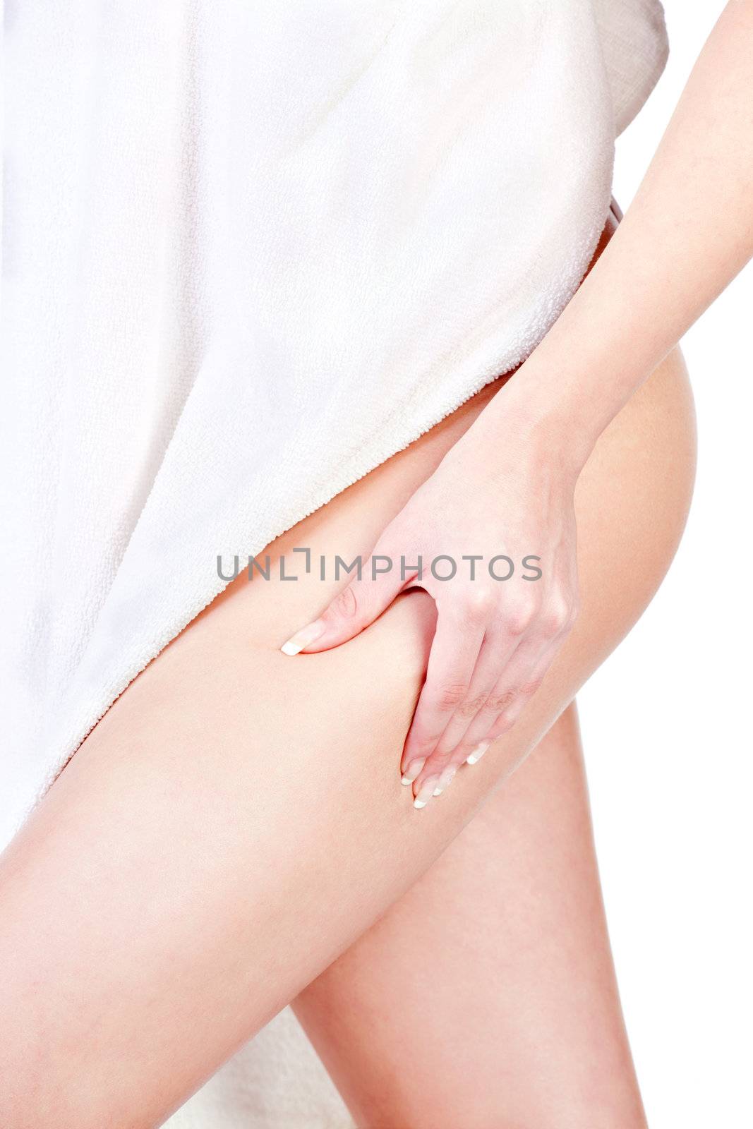 Woman with towel pinching leg for skin fold test, isolated on white