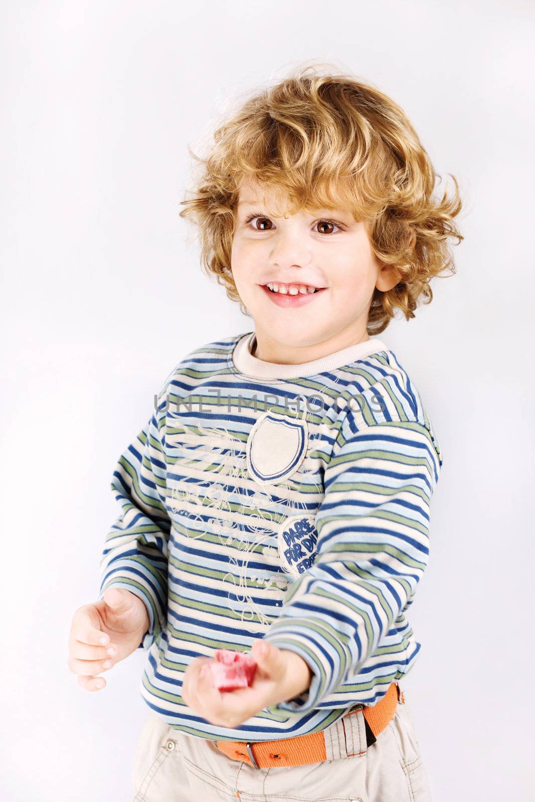 Boy holding candy in one hand