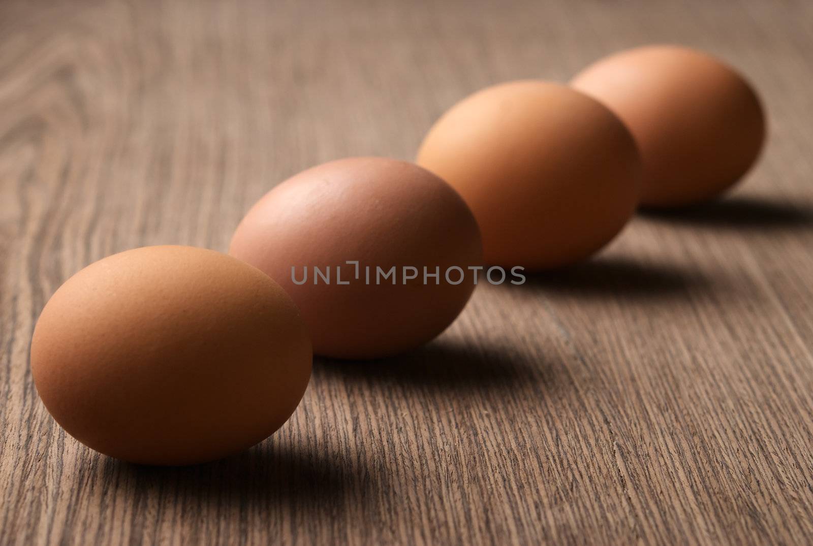 Brown eggs in a line on white background