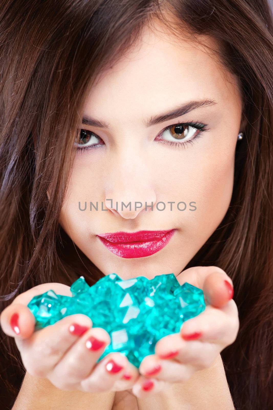 Close up of a pretty woman with blue rocks